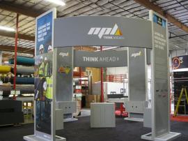 Modified ECO-4008 that Converts to a 10x20 Inline. Includes silver LED Lights, Monitor Mounts, Locking Storage, and SEG Fabric Graphics. Shown with a Modified ECO-31C Counter with Locking Storage -- Image 1