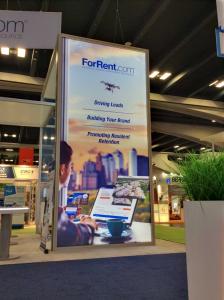 RENTAL: Custom Island Design with 18 & 14 ft. Canopy Structures with SEG Sheer Fabric, 18 ft. High Double-Sided Lightbox with One-Piece Silicone Edge Fabric Graphics -- Image 7