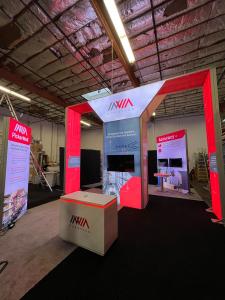 RENTAL: Modified RE-9043 Converted to a 30 x 40 Island Design with Custom Backlit Arch Tower, Storage Closet with Locking Door, Ceiling Canopy, and (2) Double-Sided Lightboxes, Also Includes (2) Freestanding 8 x 12 Double-Sided Lightboxes,(1) Freestanding