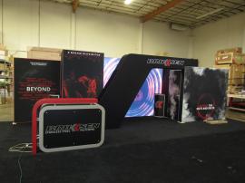 Custom Inline Exhibit with SEG and Pillowcase Fabric Graphics, Backlit Lightbox, Closet Storage, Large Monitor Mount, and MOD-1540 Reception Counter with Locking Storage