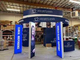 GK-5038 Gravitee Island Exhibit with Tension Fabric Graphics, (3) Double-sided Lightboxes, 16 ft. Tower, Locking Closet Storage, Reception Counter with Lockign Storage, Monitor Mount, and Curved Headers