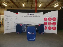 Modified SYK-2009 Symphony Portable Display with Large Monitor Mount, (2) SYM-408B Backwall Counters, (1) SYM-408 Reception Counter with Storage, and SEG and Vinyl Graphics