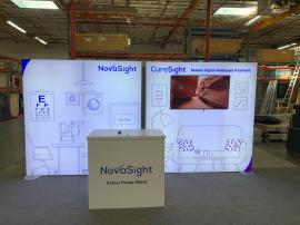 RENTAL: RE-2045 Inline Rental Design with (2) 84" x 84" Single-Sided Lightboxes, RE-1202 Reception Counter with White Laminate Top, Large Monitor Mount, 50" Monitor, SEG Fabric Graphics, and Direct Print Sintra Graphic