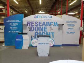 Modified SYk-2006 Symphony Portable Display with SYM-408 Portable Locking Counter, (2) Backwall Workstations, (2) SYM-1381 Aluminum Literature Trays, (2) Shelves, and Multiple Floating Graphics