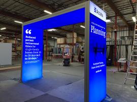 RENTAL: Backlit Arch Canopy Structure from RE-9193 Island Design with (2) 4 ft. Wide x 10 ft. High Double-Sided Lightboxes, Boomerang Baseplates, (1) 4 ft. Wide x 12ft. Long Single-Sided Ceiling Lightbox with Fabric Blocker Panel, (2) Large Monitor Mounts