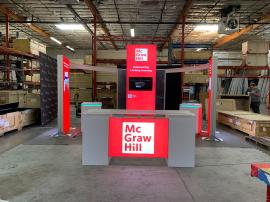 RENTAL: RE-9096 Island Design with 5 ft. Wide x 12 ft. High Double-Sided Lightbox, Frosted Acrylic Curved Framed Accent Panels, Curved Bridged Extrusion Headers, (2) 4 ft. Wide x 8 ft. High Double-Sided Lightboxes, RE-1587 Backlit Reception Counter, (2) R