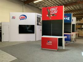 Island Design with (2) Gravitee Panel System Enclosed Conference Rooms with Locking Doors and White PVC Insert Panels for Interior Walls, storage Closet with Locking Door, (4) 12' High Gravitee Panel System Kiosks with Black Slatwall Sections, (3) RE-1576