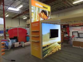Custom Island Exhibit with Backlit Fabric Graphics, Shelves, Product Displays, Reception Counter, Monitor Mounts, Closet Storage, and Arbor Canopy