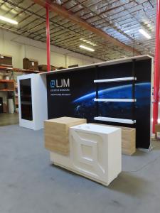Custom Inline Exhibit with Vertical Monitor Mount Display, Backlit Fabric Graphic, Shelves, and Custom Counter with Backlit Logo and Locking Storage