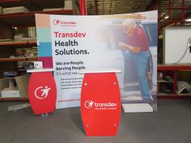 SYK-1014 Symphony Portable Display with SEG Fabric Graphic, Workstation with Wireless Charging Pad, SYM-408 Counter with Locking Storage, Monitor Mount, and LED Stem Lights