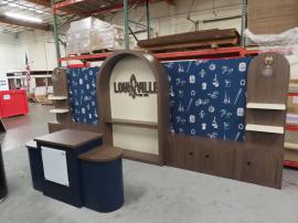 Custom Wood Fabrication Inline Exhibit with (1) Center Arch, (2) Side Arches, Shelves, Locking Backwall Cabinets, Fabric Graphics, and Custom Reception Counter with Locking Storage