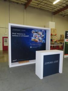 Modified VK-1340 Custom Exhibit with Backlit SEG Fabric Graphic and MOD-1563 Counter with LED Accent Lights and Locking Storage -- View 2