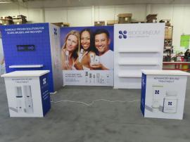 Gravitee Modular Inline Exhibit with Tension Fabric Graphics, SuperNova Lightbox, Shelves, Monitor Mount, Closet Storage, and (2) MOD-1703 Reception Counters -- View 5