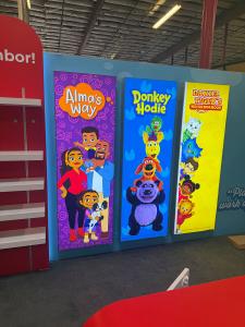 Reconfigurable Gravitee Modular Exhibit with Closet Door Storage, Halo Lit Logo, Shelving, Monitor Mount, (3) Hanging Backlit Graphics, (4) Literature Holders, and (2) Custom Reception Counter with LED Accent Lights and Locking Storage -- View 3