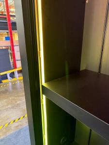 Custom Display Arch with Halo Lit Logo, RGB Programmable Lighting, Adjustable Shelves, and Product Displays -- View 4