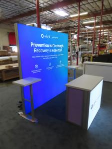 VK-1970 Backlit SuperNova Exhibit with Tension Fabric Graphic and MOD-1700 Backlit Counter with Locking Storage